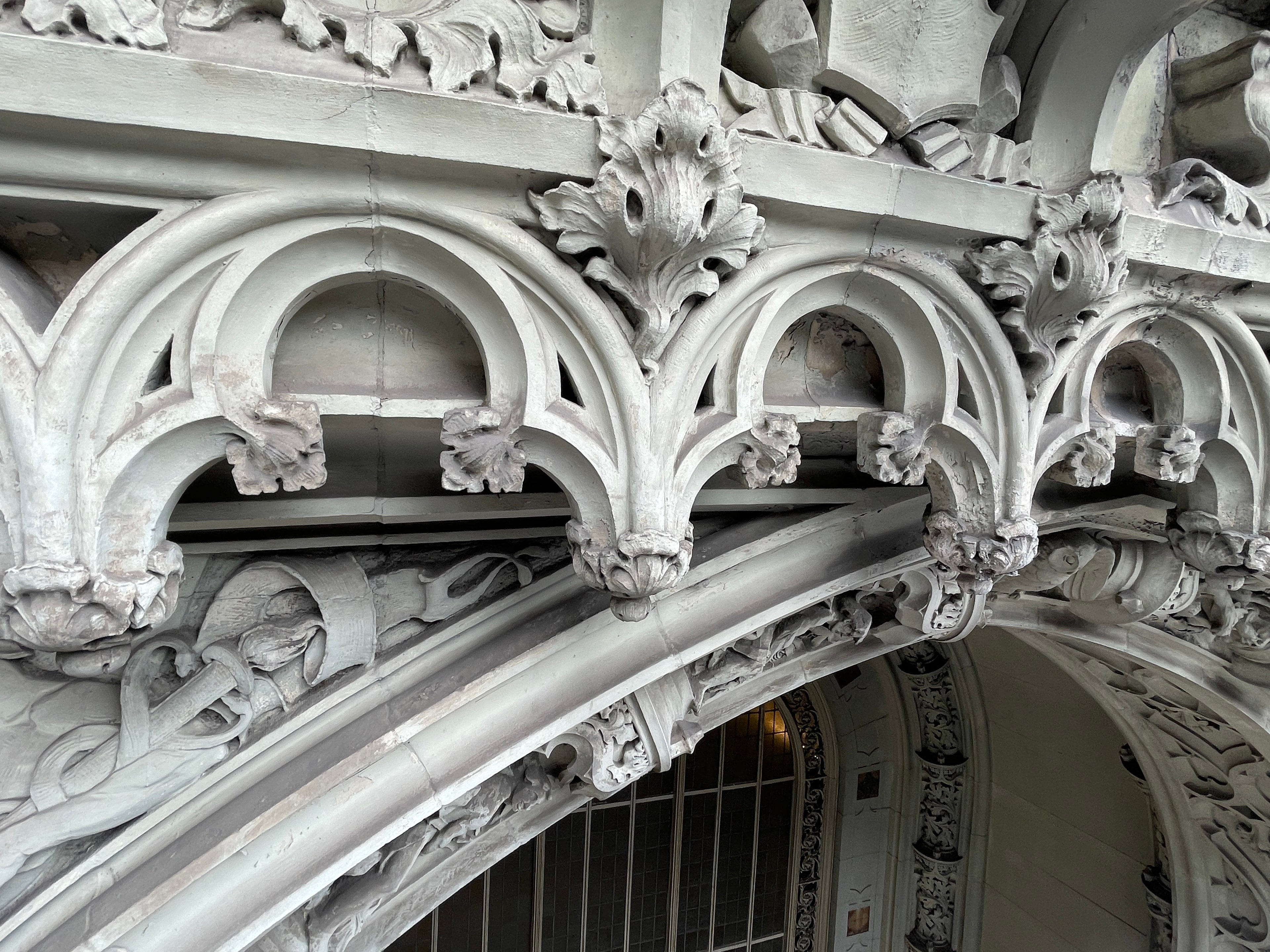 Close-range view of the Woolworth Building's limestone arch tracery and foliate ornament