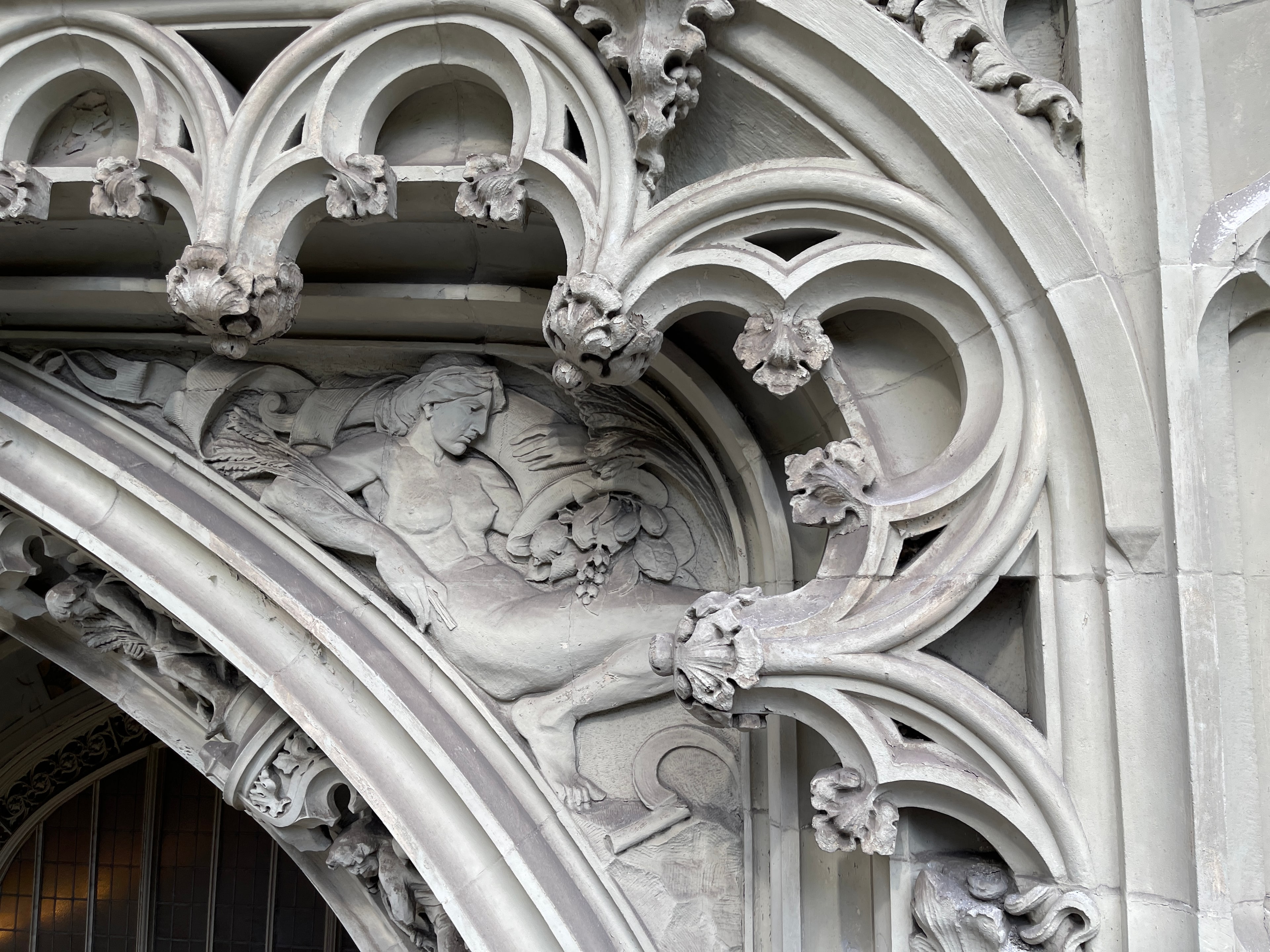 Sculpted figure, foliate ornament and curved terra cotta tracery at the Woolworth Building
