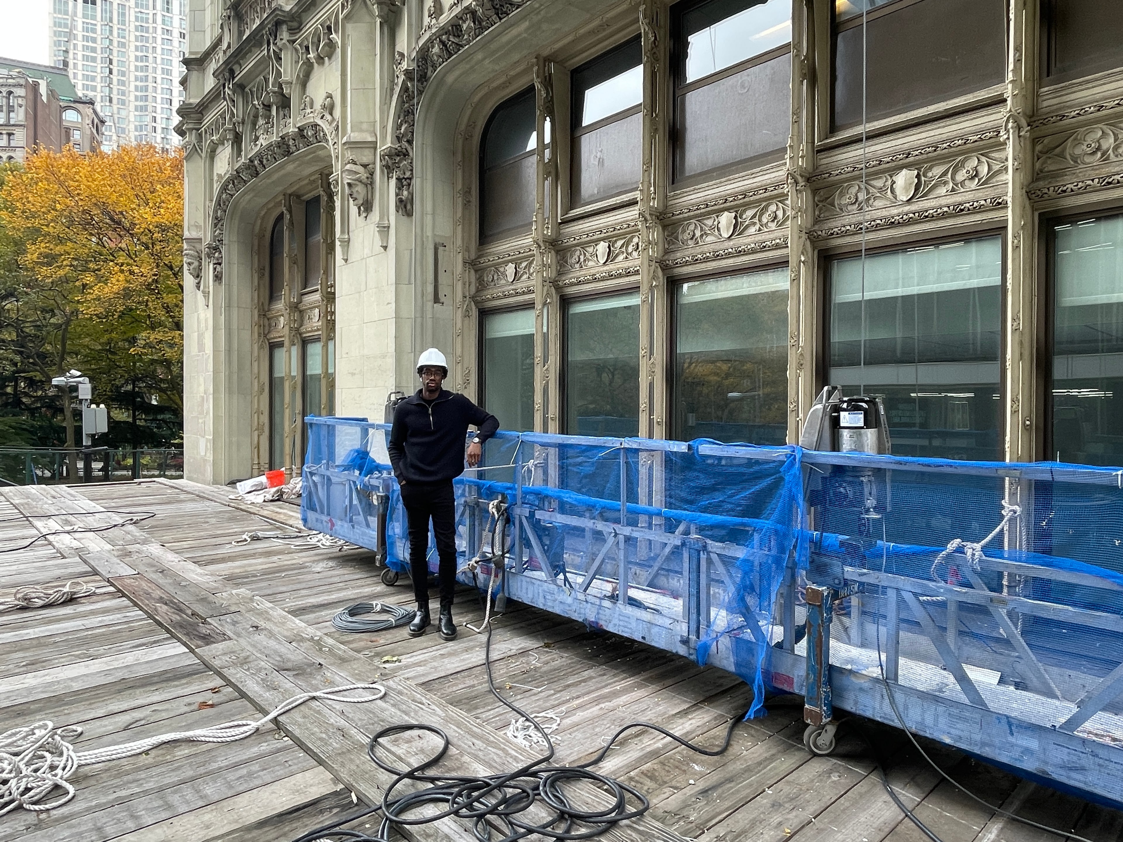 Jeremy Edwards beside suspended-scaffold equipment along the Woolworth Building's lower facade