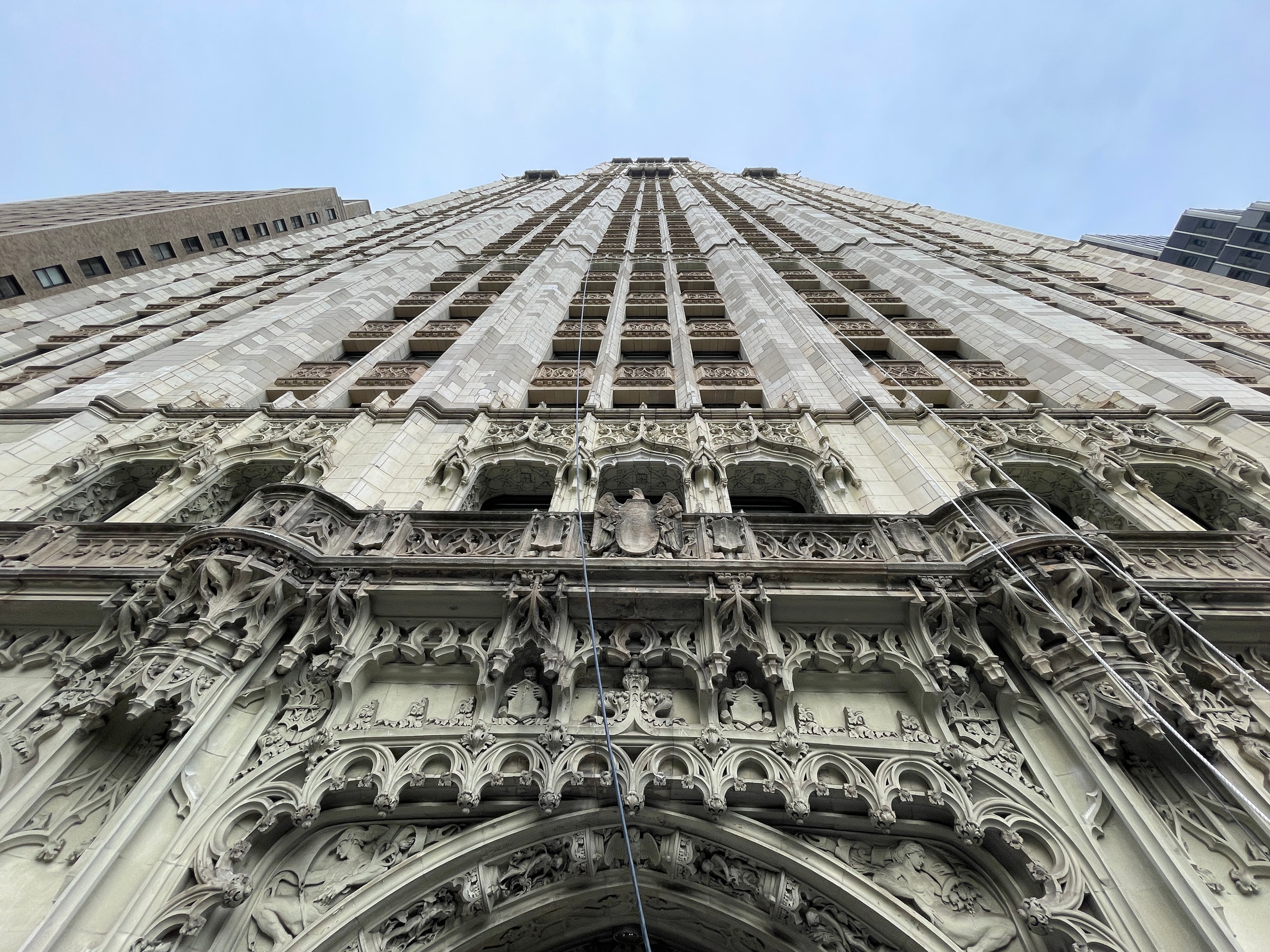 Upward view of the Woolworth Building facade above the ornamental entrance arch