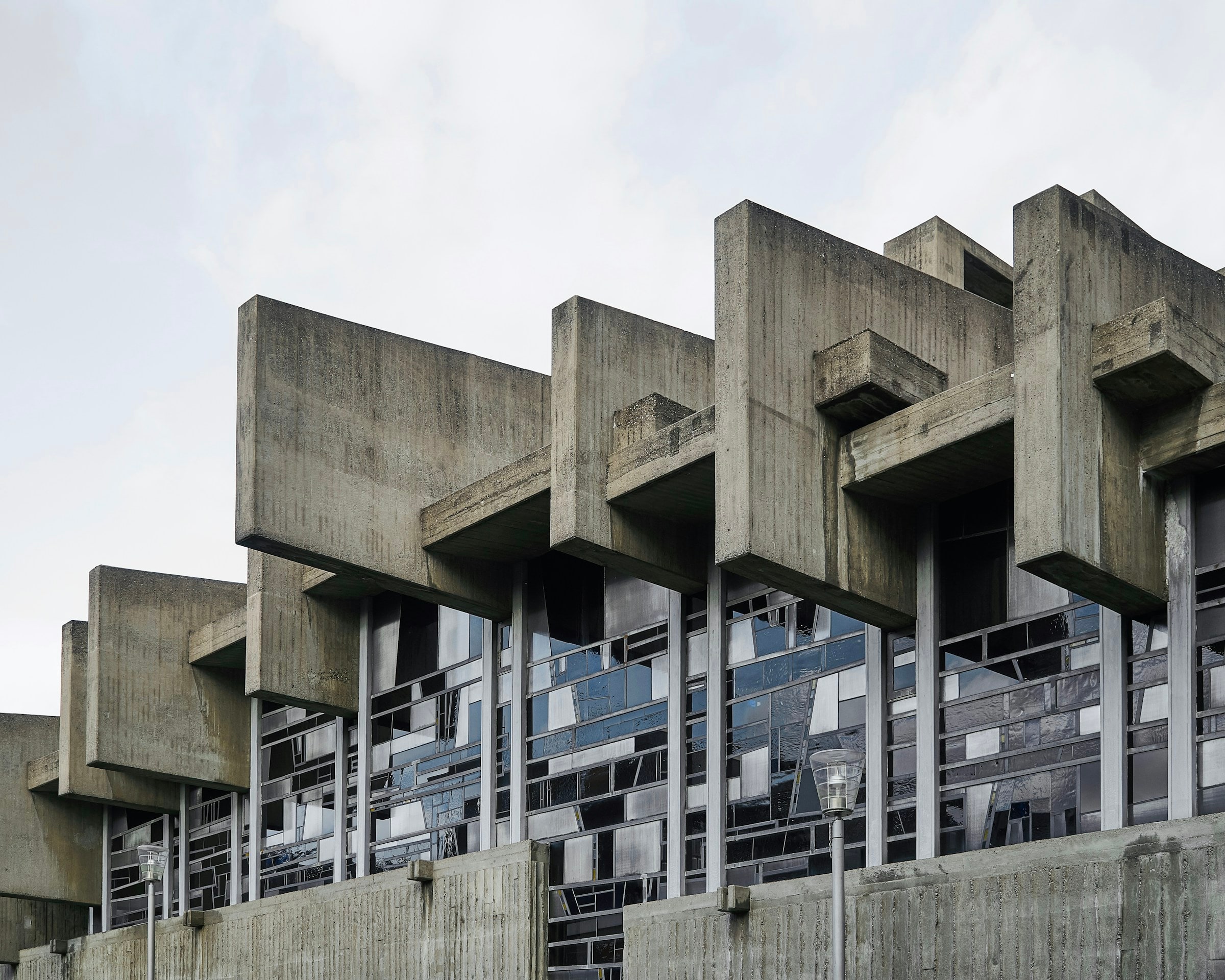 Exposed concrete facade with projecting geometric elements and weathered surfaces