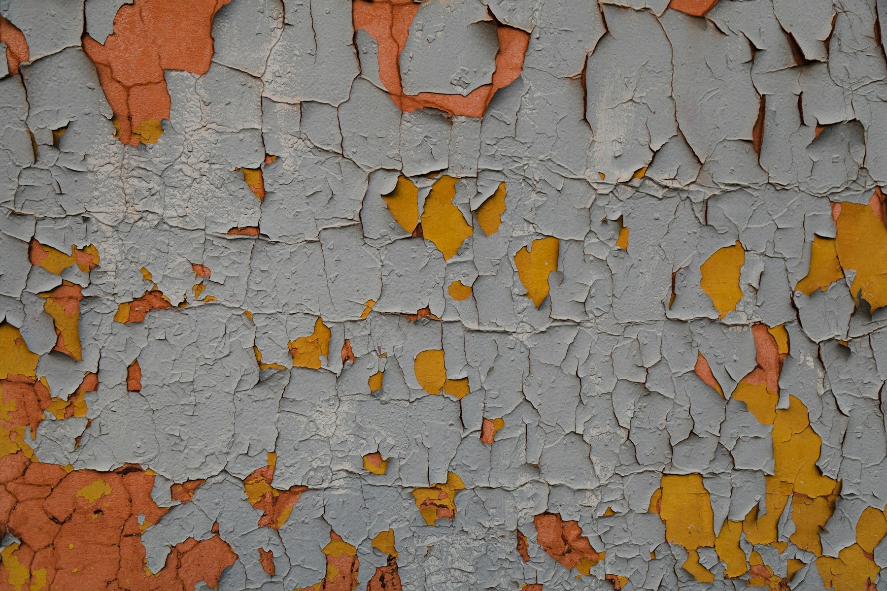 Weathered exterior coating with exposed layers and peeling paint