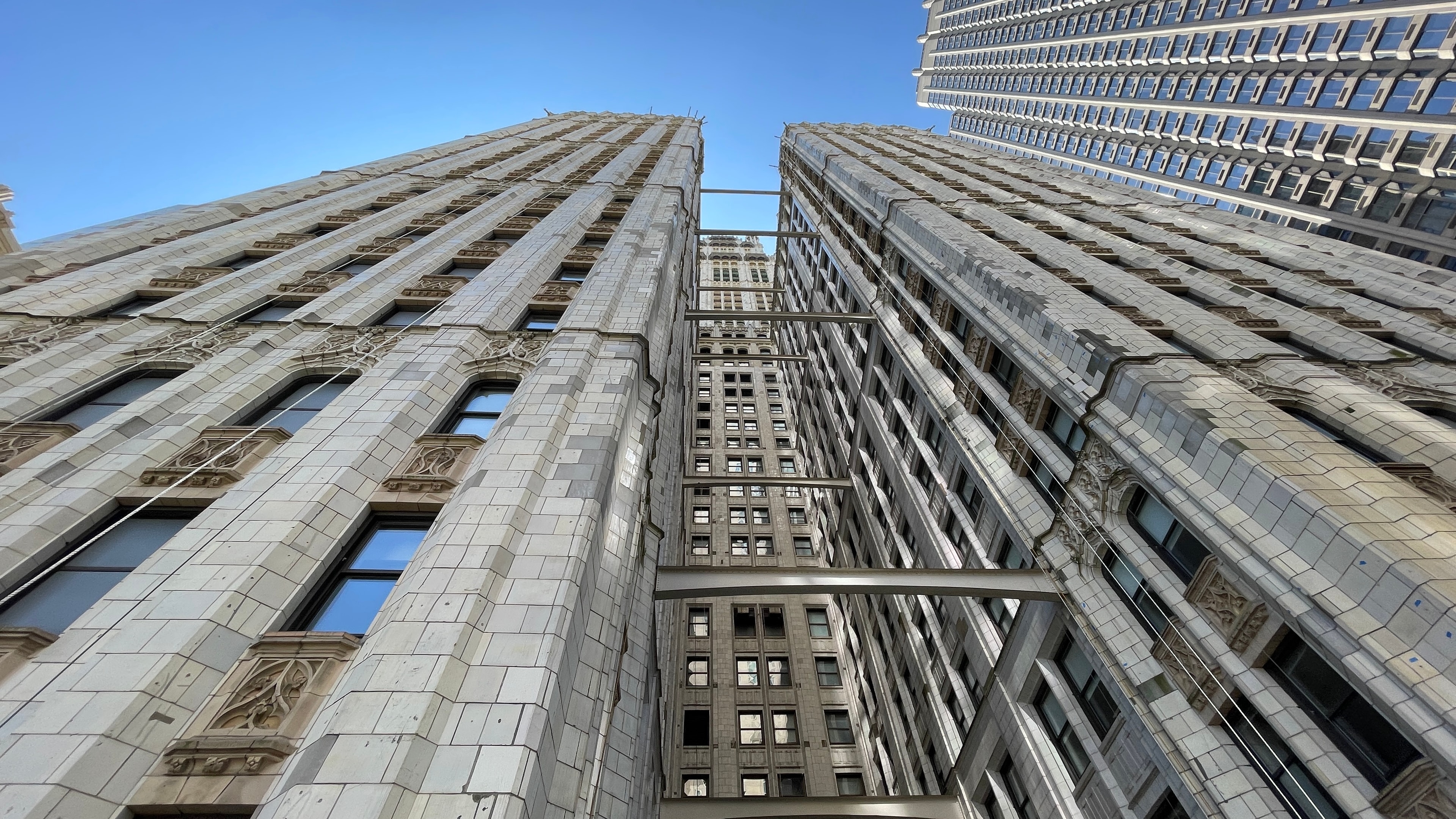 Upward view of historic terra cotta facades and connecting structural elements